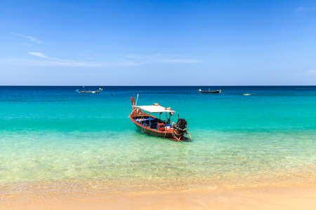 Traditional thai longtail boat at famous sunny Long Beach, Thailand, phuket province, Andaman seaの写真素材