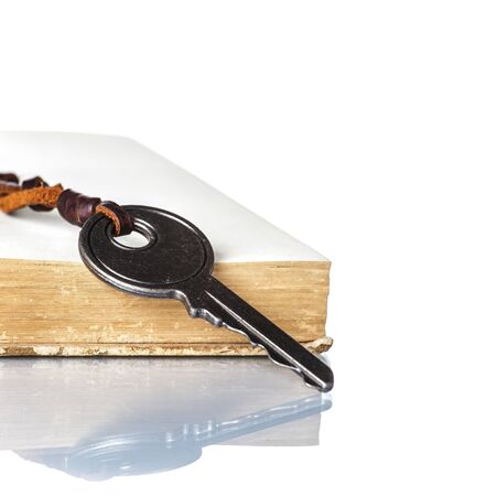 Key and Old Book on white backgroundの写真素材