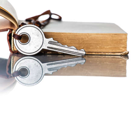Key and Old Book on white backgroundの写真素材