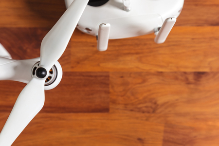 White Drone on wooden background