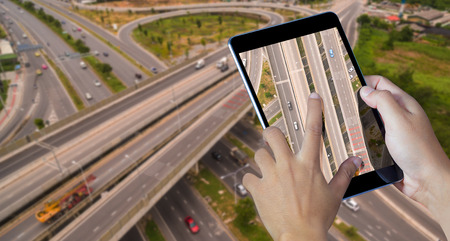 Hand holding the digital tablet with street mapsの写真素材