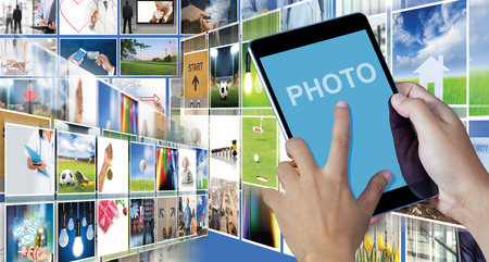 Hand holding the digital tablet with Picture galleryの写真素材