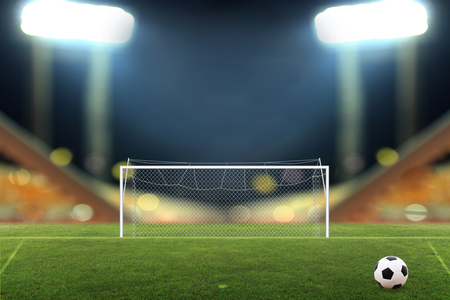 Soccer ball on Soccer stadium with bright spotlightsの写真素材