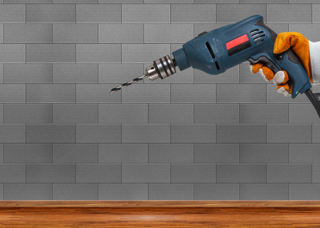 Builder or worker drilling with a machine or drillの写真素材