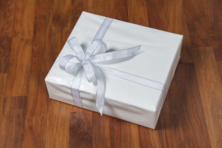 White gift box on a wooden backgroundの写真素材