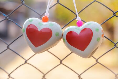 Heart toys on the cage metal net backgroundの写真素材