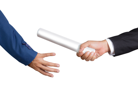 Cropped hand of businessman passing relay baton to colleague, the concept of teamwork for business successの写真素材