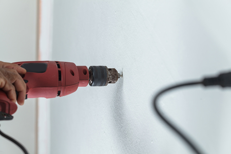 Builder or worker drilling with a machine or drillの写真素材