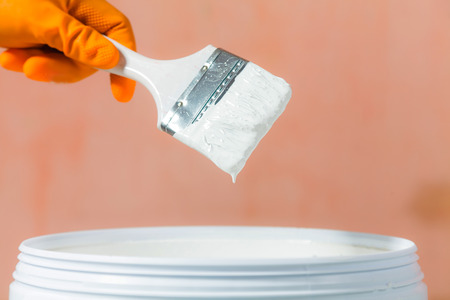 Painter painting the walls white in houseの写真素材