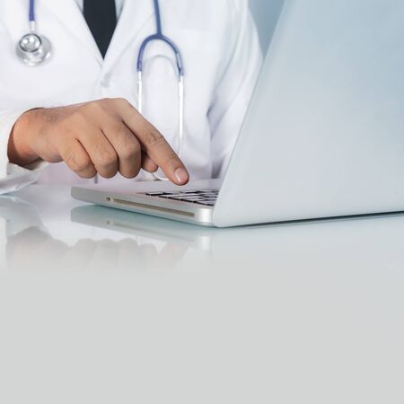 Healthcare And Medicine, Doctor with stethoscope and Laptop on desk