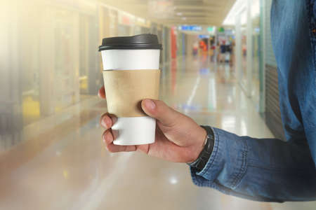 A young man holding a coffeeの写真素材