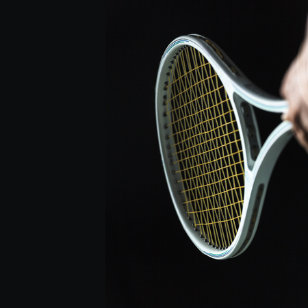 Tennis racket on black background