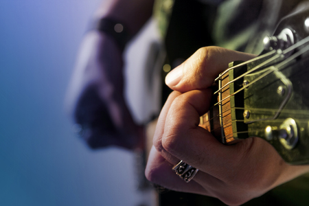 Electric guitar player on a stage, live in concert