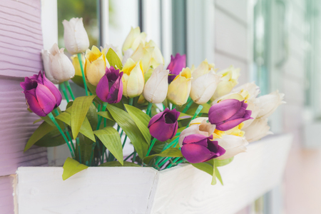 Beautiful artificial flowers in front of the houseの写真素材