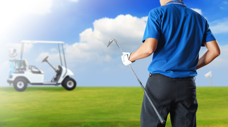 Golf player holding a golf club in golf courseの写真素材