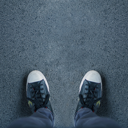 Pair of shoes standing on walkwayの写真素材