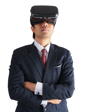Portrait of businessman in a suit with virtual reality glasses isolated on backgroundの写真素材