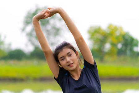 Portrait of beautiful girl in sportswear smiling during exerciseの写真素材