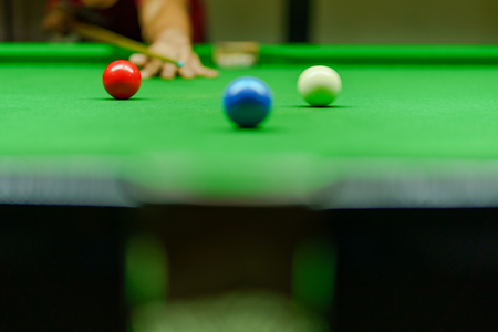Player was shooting ball on green snooker table