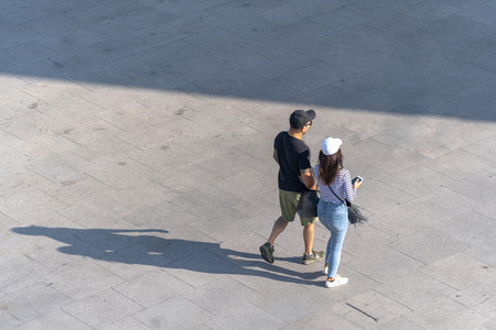 Aerial photo of people walk on the walkway in front of the mall in the cityの写真素材