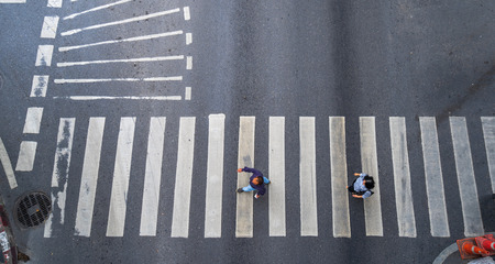 Aerial photo top view of people walk on street in the city over pedestrian crossing traffic roadの写真素材