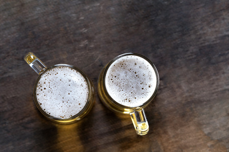 Top view of Beer in glass on the wooden table backgroundの写真素材
