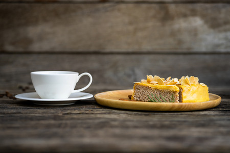 Cup of coffee with dessert on a wooden tableの写真素材