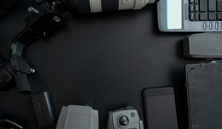 Top view of tools professional photographer and video with camera accessory on wooden background