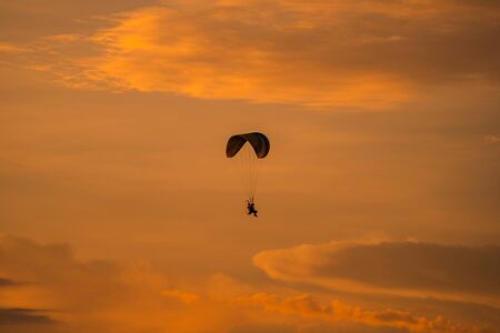 The silhouette of the paramotor at sunset