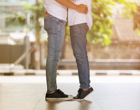 Couple kissing, girls stands on tiptoe to kiss her man