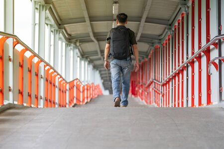 Asian man walking in the cityの写真素材