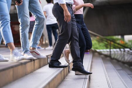 Close up of legs and shoes walking on street in the cityの写真素材