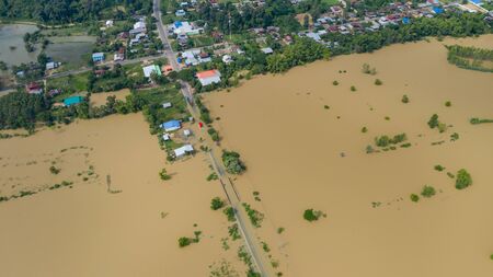 Aerial top view of Flooded rice paddies and the village, View from above shot by drone