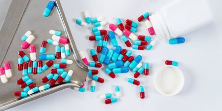 Many type of medical drugs pills capsules on white background