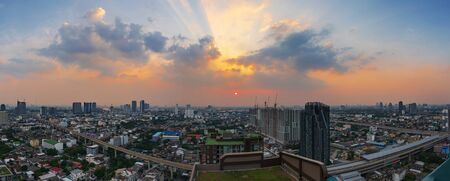 Panoramic of Bangkok - Thailand at sunset with twilight sky and skytrain in city downtown