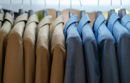 Close up of luxurious style gentlemen suit on hangers