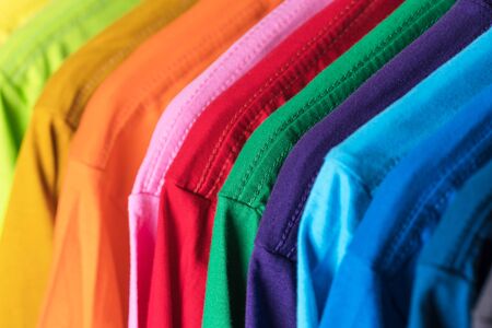 Close Up of t-shirts, Clothes on hangers on white background