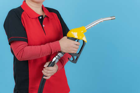 Woman hold fuel nozzle isolated on blue background