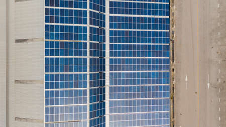 Aerial top view of the solar cells on the roof, Solar panels installed on a roof of a large...