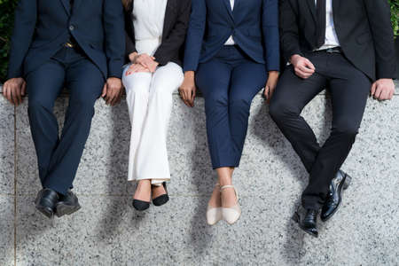 New normal, Virus Situation in Business Concept, A group of four business people with Surgical Safety Mask standing in front of modern officeの写真素材