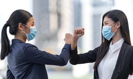 Business people walking and talk to each other in front of modern officeの写真素材