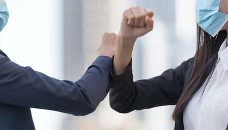 Business people walking and talk to each other in front of modern officeの写真素材