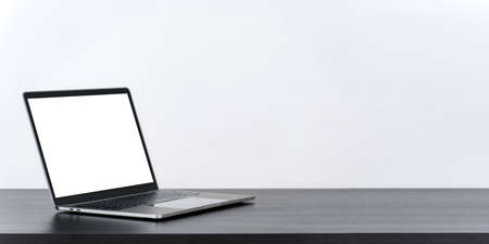Laptop computer blank white screen on table on white backgroundの写真素材