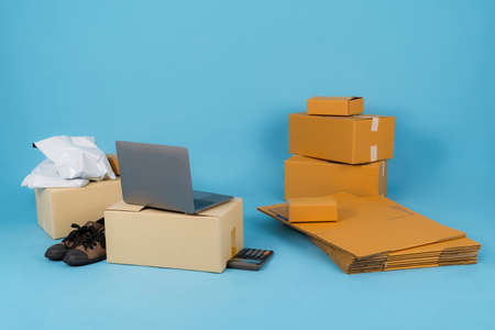 Asian woman working with calculator, Selling online ideas concept, Online seller business shop at homeの写真素材