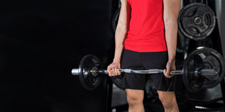 Close-up of fitness man, Handsome athletic guy workout with dumbbellsの写真素材