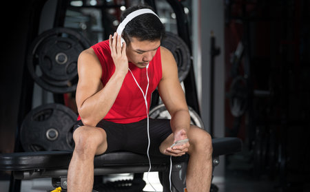 Close-up of fitness man, Handsome athletic guy workout with dumbbellsの写真素材