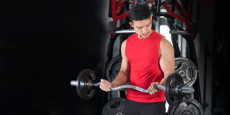 Close-up of fitness man, Handsome athletic guy workout with dumbbellsの写真素材