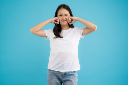 Asian girl holding a cup of pearl milk tea With a smile, fun and happiness on a blue background.の写真素材