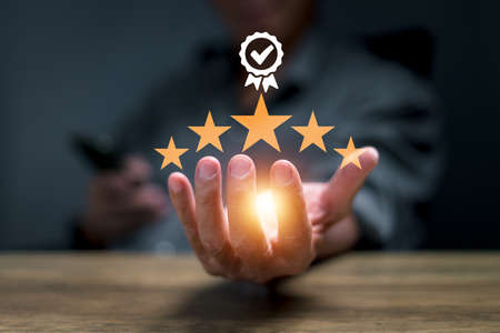 businessman hand showing sign of top service 5-star quality assurance, warranty, standardization,...