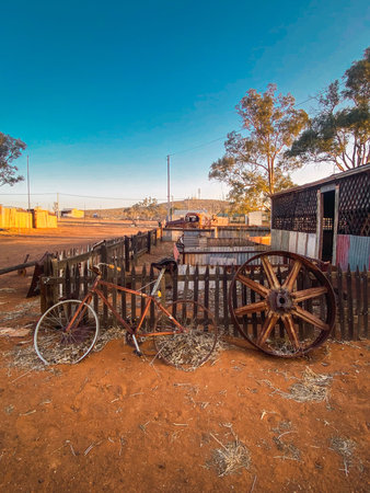 Rusty bicycle and wagon wheel in australian outback